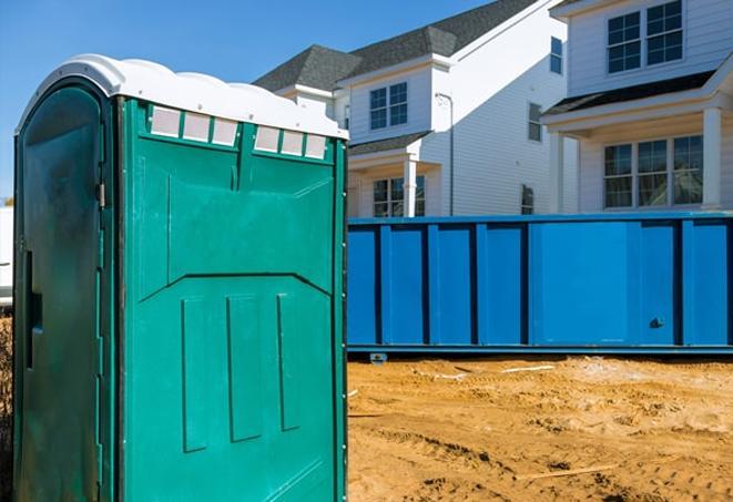 a row of porta potties located at a busy job site